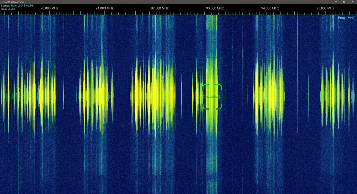 The spectrum laid flat across a screen: bright yellow columns burning through the blue static, time falling downward like slow rain in neon